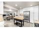 Open concept kitchen with stainless steel appliances, center island, and a seamless transition to dining area at 8762 Mourning Dove Ln, Highlands Ranch, CO 80126