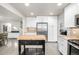 Well-equipped kitchen featuring stainless steel appliances, bright white cabinetry, and a functional center island at 8762 Mourning Dove Ln, Highlands Ranch, CO 80126