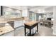 Modern kitchen with granite countertops, stainless steel appliances, and views of dining and living areas at 8762 Mourning Dove Ln, Highlands Ranch, CO 80126