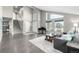 Large open living room featuring stairs, ample natural light and gray hardwood floors at 8762 Mourning Dove Ln, Highlands Ranch, CO 80126