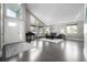 Bright living room featuring hardwood floors, large windows, and modern furnishings at 8762 Mourning Dove Ln, Highlands Ranch, CO 80126