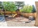 Backyard play area with a wooden playset, slide, and swing for outdoor fun at 8762 Mourning Dove Ln, Highlands Ranch, CO 80126
