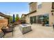 Spacious backyard with concrete patio, fire pit, seating, grill, and sliding glass doors at 9636 Bennett Peak St, Littleton, CO 80125