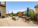 Outdoor patio with modern firepit and seating, perfect for entertaining and relaxing in a private backyard at 9636 Bennett Peak St, Littleton, CO 80125