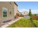 Landscaped backyard with lawn, stone path, wooden fence, garden, and modern hot tub at 9636 Bennett Peak St, Littleton, CO 80125
