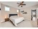 Neutral main bedroom with cozy bed and accents with natural light and an adjoining area at 9636 Bennett Peak St, Littleton, CO 80125
