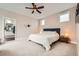 Neutral main bedroom with cozy bed and accents with natural light and an adjoining bathroom at 9636 Bennett Peak St, Littleton, CO 80125