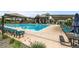 Resort-style community pool with lounge chairs, umbrellas, and a modern clubhouse at 9636 Bennett Peak St, Littleton, CO 80125