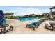 Community pool with lounge chairs, umbrellas, and seating areas for residents at 9636 Bennett Peak St, Littleton, CO 80125