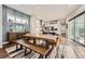 Dining area featuring a wooden table and bench, with an open view into the modern, well-lit kitchen at 9636 Bennett Peak St, Littleton, CO 80125