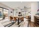 Open-concept dining area with a wooden table, stylish chairs, and seamless flow into the living spaces at 9636 Bennett Peak St, Littleton, CO 80125
