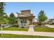 Contemporary two-story home featuring a well-manicured front yard, a covered porch, and stylish architectural details at 9636 Bennett Peak St, Littleton, CO 80125