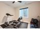 Home gym featuring a treadmill, weight bench, dumbbells, and a window bringing in natural light at 9636 Bennett Peak St, Littleton, CO 80125