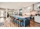 Spacious kitchen with a large center island, modern lighting, and bar stool seating at 9636 Bennett Peak St, Littleton, CO 80125