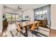 Open floor plan combining living and dining areas, highlighted by modern decor and an abundance of natural light at 9636 Bennett Peak St, Littleton, CO 80125