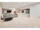 Spacious living room with recessed lighting, a sectional sofa, and a wall-mounted television at 9636 Bennett Peak St, Littleton, CO 80125