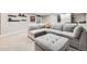 Inviting living room features a plush sofa, ottoman, and built-in bookshelves and cabinetry at 9636 Bennett Peak St, Littleton, CO 80125