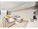Finished basement Gathering room with plush seating, carpet, and built-in shelving creating a comfortable retreat at 9636 Bennett Peak St, Littleton, CO 80125