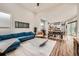 Open-concept living space with modern furnishings, seamlessly connecting the living room, dining area, and kitchen at 9636 Bennett Peak St, Littleton, CO 80125