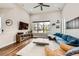 Spacious living room with large window, vaulted ceiling, and modern furniture, creating a cozy and inviting atmosphere at 9636 Bennett Peak St, Littleton, CO 80125