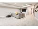 Expansive living room with large sectional sofa, tv, and shelving, ideal for a relaxing gathering space at 9636 Bennett Peak St, Littleton, CO 80125
