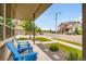Inviting front porch with blue chairs offering a view of the street and neighborhood at 9636 Bennett Peak St, Littleton, CO 80125