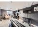 Finished basement serves as a gaming room with a large screen TV, gaming chairs, and black futon at 5550 E 130Th Dr, Thornton, CO 80241