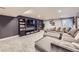 Finished basement features plush carpet, recessed lighting, entertainment center, and comfortable oversized sectional sofa at 5550 E 130Th Dr, Thornton, CO 80241