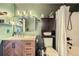 Stylish bathroom with wooden vanity, shower, decorative mirror, and fixtures at 5550 E 130Th Dr, Thornton, CO 80241