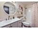 Bright bathroom featuring white vanity, shower, decorative mirror, and fixtures at 5550 E 130Th Dr, Thornton, CO 80241