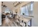 Cozy dining area with wood table, modern light fixture, and views to the living room at 5550 E 130Th Dr, Thornton, CO 80241