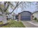 Charming blue home with a two-car garage, brick accents, and a well-maintained lawn at 5550 E 130Th Dr, Thornton, CO 80241