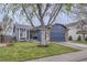 Charming blue home with a two-car garage, brick accents, and a well-maintained lawn at 5550 E 130Th Dr, Thornton, CO 80241