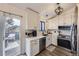 Modern kitchen featuring stainless steel appliances, white cabinets, and sliding door access at 5550 E 130Th Dr, Thornton, CO 80241