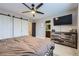 A main bedroom with a barn door closet, TV, dresser and adjoining bathroom at 5550 E 130Th Dr, Thornton, CO 80241