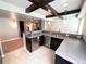 Contemporary basement bar with stainless steel appliances, dark wood cabinetry, and tile flooring at 5660 E Burlington Dr, Castle Rock, CO 80104