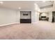 Spacious basement living area with neutral carpet, fireplace, and built in media cabinet at 5660 E Burlington Dr, Castle Rock, CO 80104