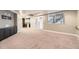 Large basement living area with walkout access, media cabinet and bar area at 5660 E Burlington Dr, Castle Rock, CO 80104