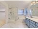 This bright bathroom offers double sinks, a standalone soaking tub, and a glass-enclosed shower at 5660 E Burlington Dr, Castle Rock, CO 80104