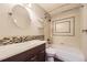 This updated bathroom features a modern vanity and updated tile surround on the shower and tub at 5660 E Burlington Dr, Castle Rock, CO 80104
