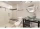 Modern bathroom with a glass enclosed shower, tiled walls, and a sleek glass vessel sink at 5660 E Burlington Dr, Castle Rock, CO 80104