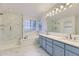 Bright primary bathroom with double sinks, a glass-enclosed shower, and a standalone soaking tub at 5660 E Burlington Dr, Castle Rock, CO 80104