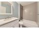 This modern bathroom features a marble vanity, updated fixtures, and new tile in the shower at 5660 E Burlington Dr, Castle Rock, CO 80104