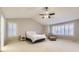 Spacious bedroom offers lots of natural light and features a ceiling fan, plantation shutters, and neutral carpet at 5660 E Burlington Dr, Castle Rock, CO 80104