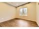 This light and airy bedroom features hardwood floors and a window offering plenty of natural light at 5660 E Burlington Dr, Castle Rock, CO 80104