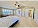 This spacious bedroom features a vaulted ceiling, a ceiling fan, built-in shelving, and natural light at 5660 E Burlington Dr, Castle Rock, CO 80104
