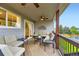 Inviting covered deck featuring comfortable seating and a view of the landscaped backyard at 5660 E Burlington Dr, Castle Rock, CO 80104