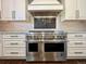 Well-appointed kitchen with a professional-grade range and pot filler above the stove at 5660 E Burlington Dr, Castle Rock, CO 80104
