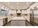 Bright kitchen with large island, stainless steel appliances, and custom white cabinets at 5660 E Burlington Dr, Castle Rock, CO 80104