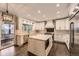 Modern kitchen with white cabinets, stainless steel appliances, and a center island at 5660 E Burlington Dr, Castle Rock, CO 80104